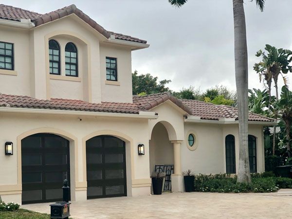 Garage doors installation. Workers installing Post Rail and Spring Installation / Assembly.