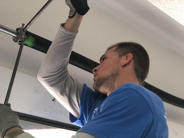 man installing garage door